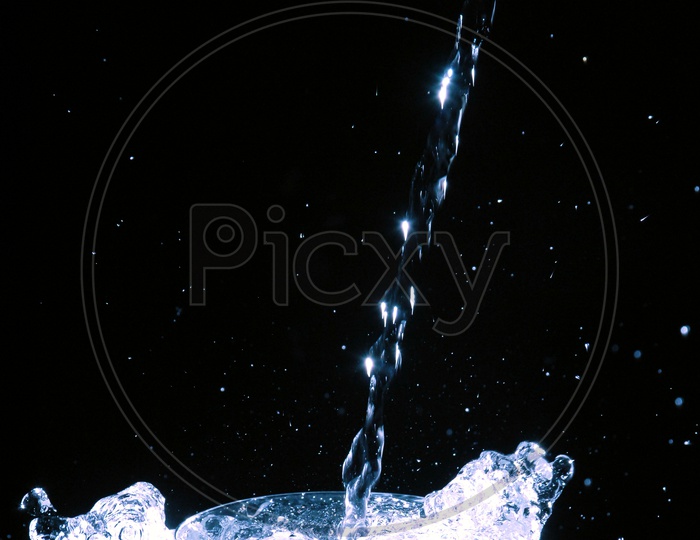 Splash of water in glass with black background