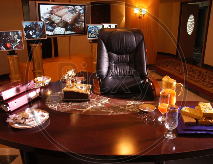 A Office Room  Chair And Table  With CCTV  Live Feed Playing on Televisions
