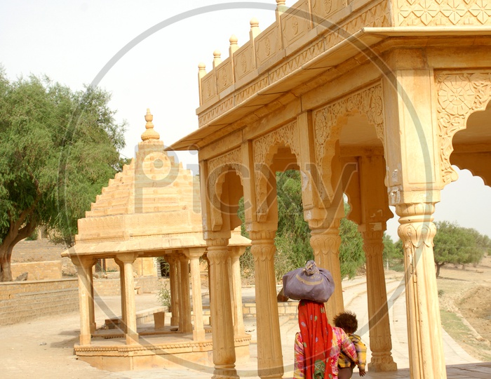 Poor Rajasthani woman walking along with her child