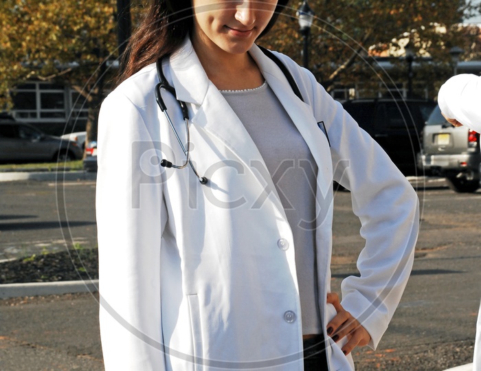 An young female doctor posing on the road