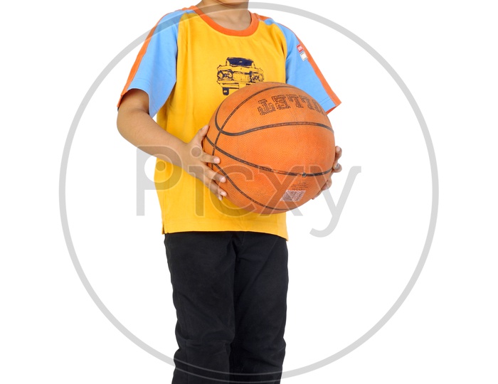 An Indian boy playing with basketball in white background