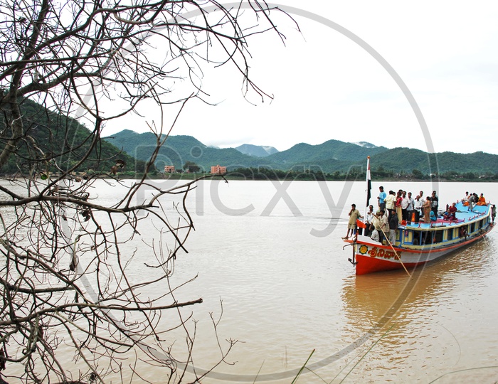 People traveling In a Boat with mountains in the background