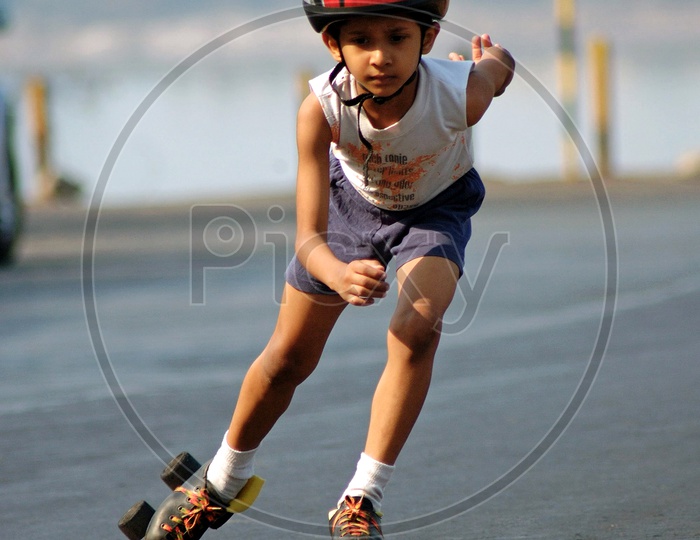 A boy skating with a helmet on the road