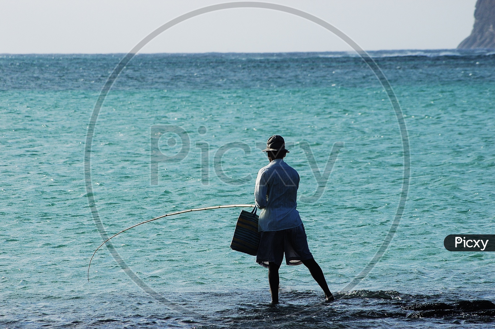 A man fishing by the sea