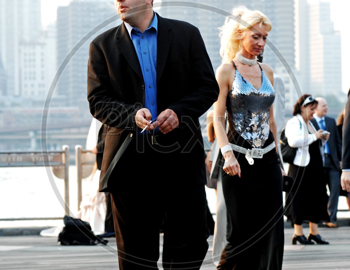 A man wearing a suit walking along with a woman