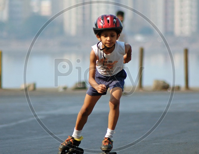A boy skating in the road wearing a helmet