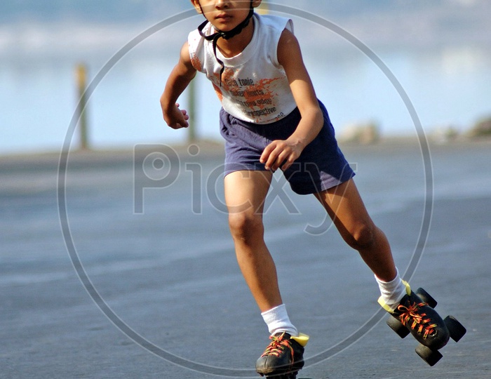 A boy skating in the road wearing a helmet