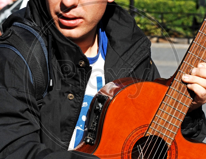 A foreigner playing guitar