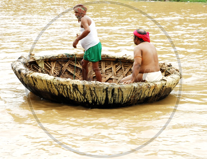 Indian People Sailing on Coracle