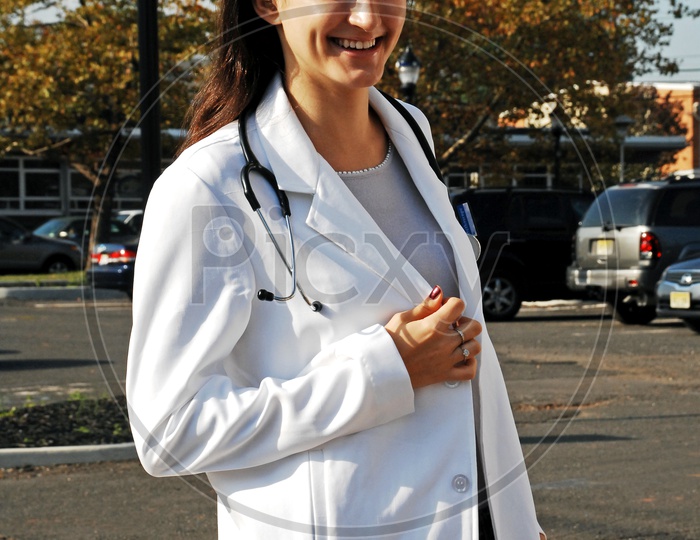 An young female doctor smiling on the road