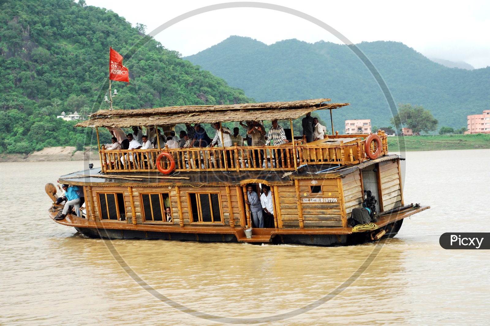 People traveling in a boat with mountains in the background