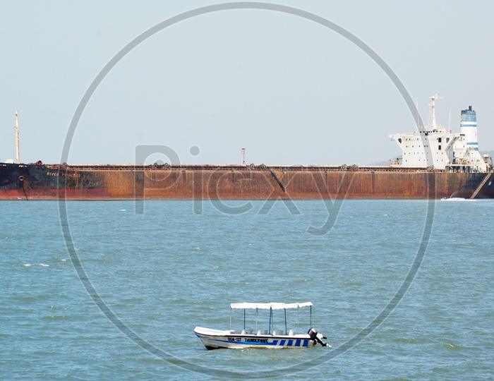 Cargo ship and a small boat in the Arabian sea