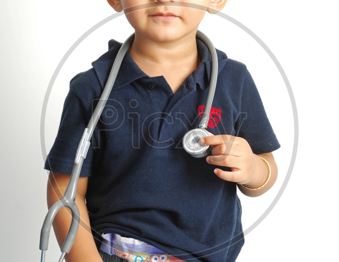 A small boy with a stethoscope around his neck