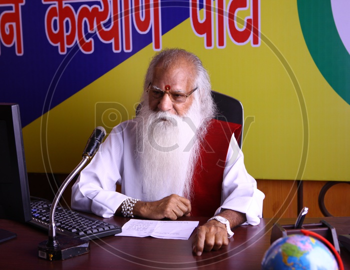An old Man Or Political Party Leader Speaking In a Party Office