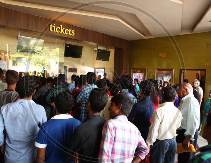 Fans Waiting at Tickets Counter in a Movie Theater