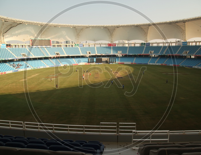 Aerial View Of Players Playing In a Cricket Stadium
