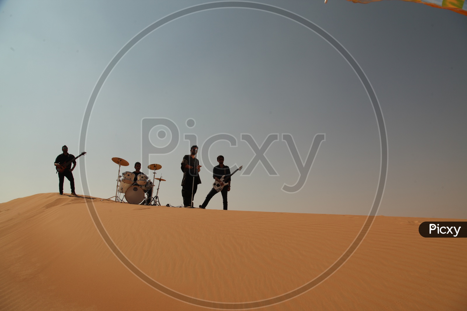 A Music Band Performing In Sand dunes of A Desert