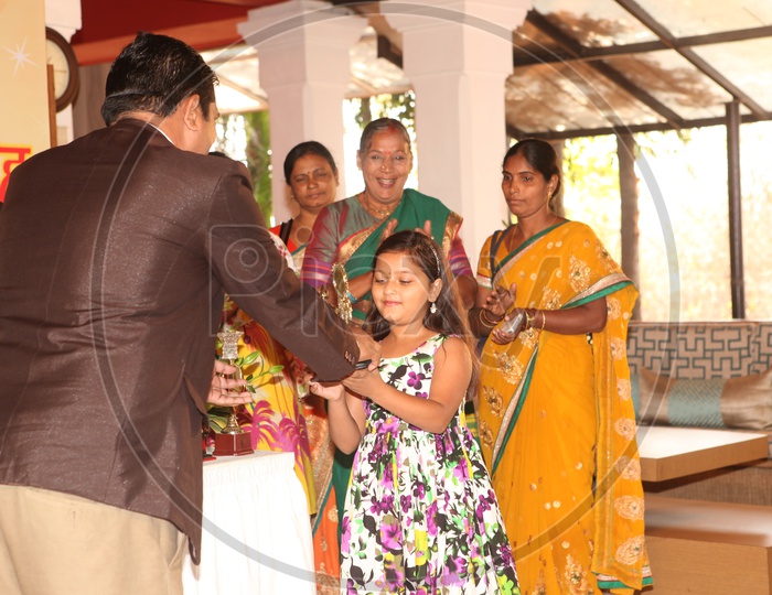 A Young Girl Receiving Award From Dignitary