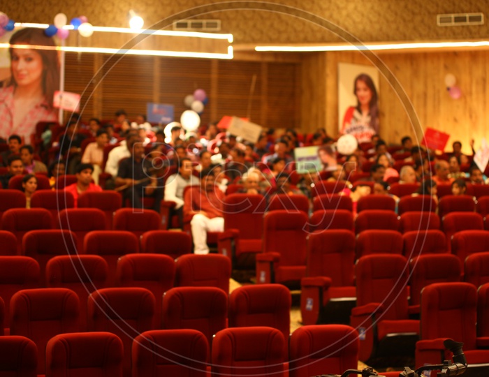 Crowd Sitting In an Auditorium