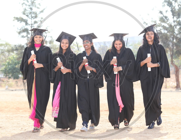 Young Indian  Students Wearing Graduation Day Dress