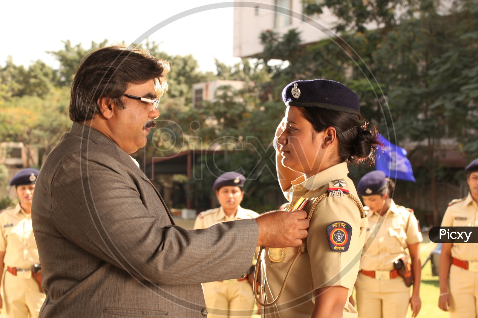 Young Woman Or Lady Police Receiving Gallantry Award From Officers