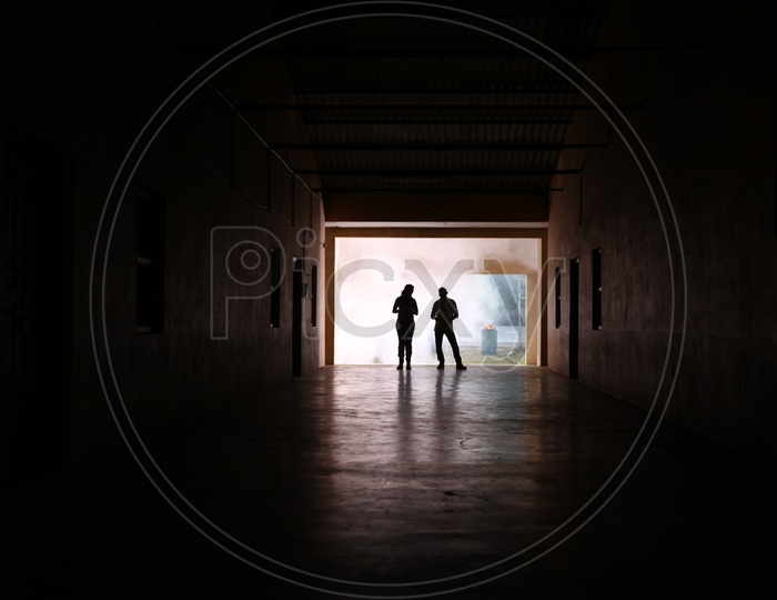 Silhouette Of People In a Corridor