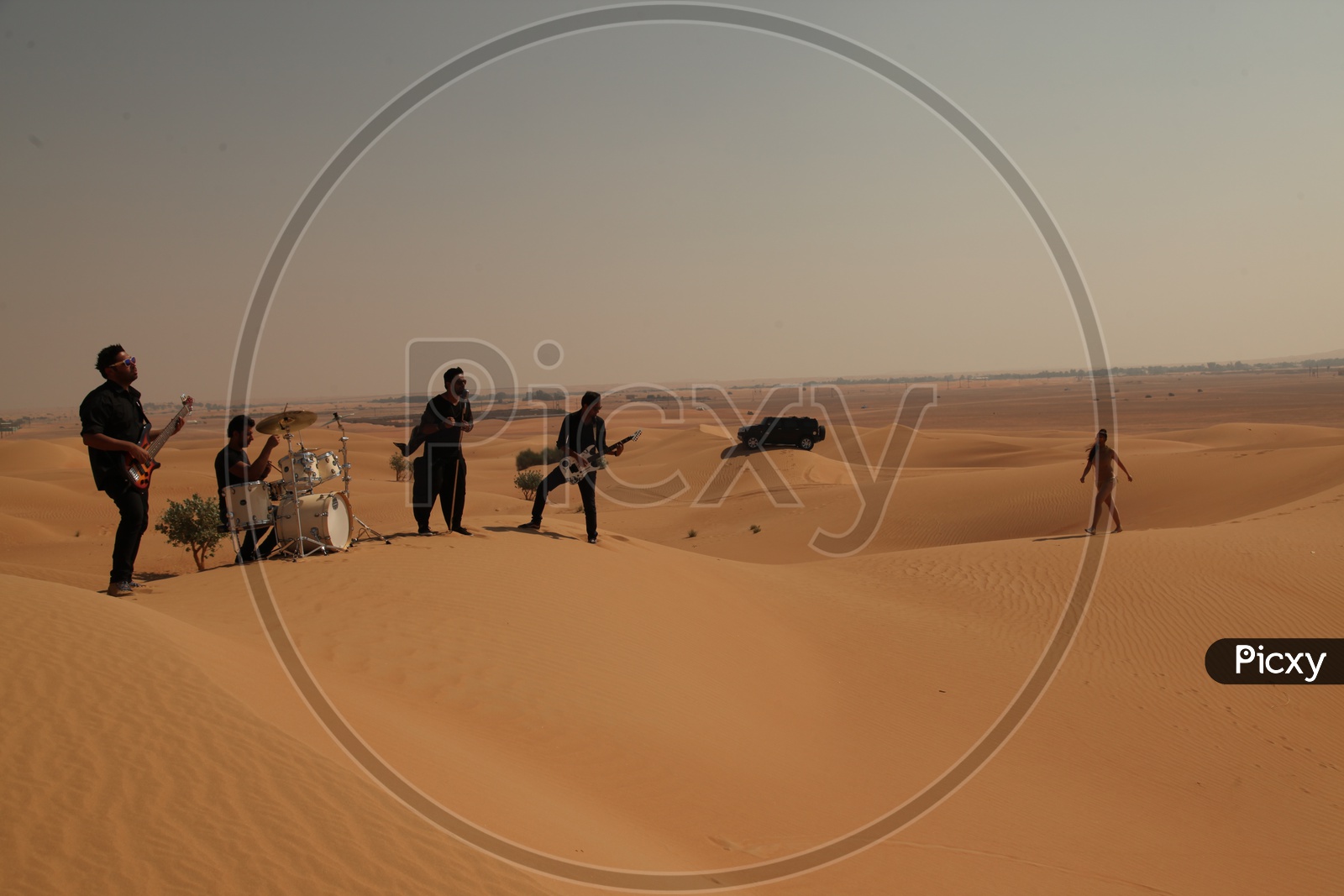 A Music Band Performing In Desert Sand Dunes For a Music album