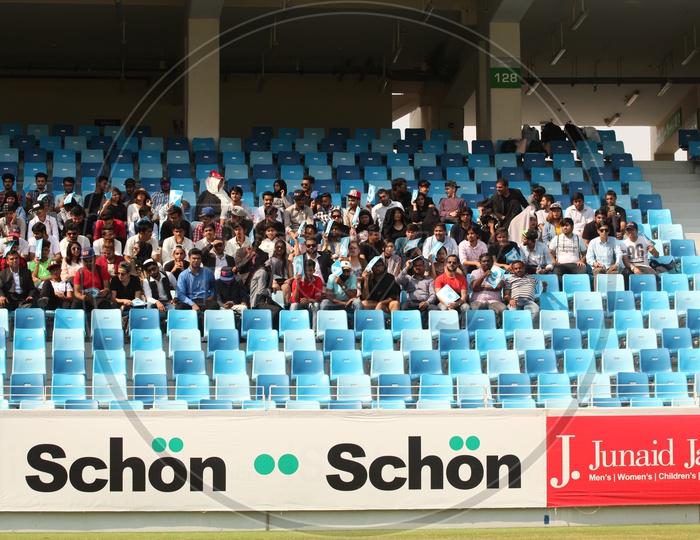 Fans Or Crowd Sitting In Stands in a Cricket Stadium