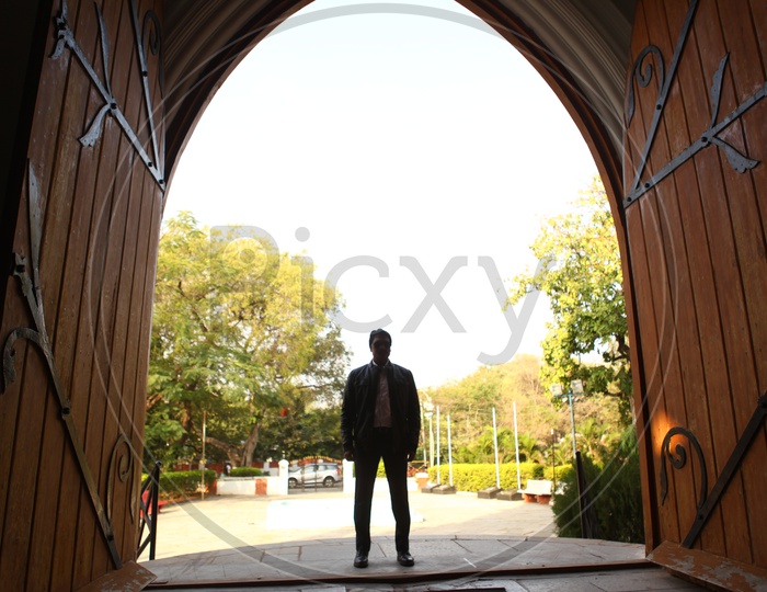 Silhouette of a man Standing at a Church Door