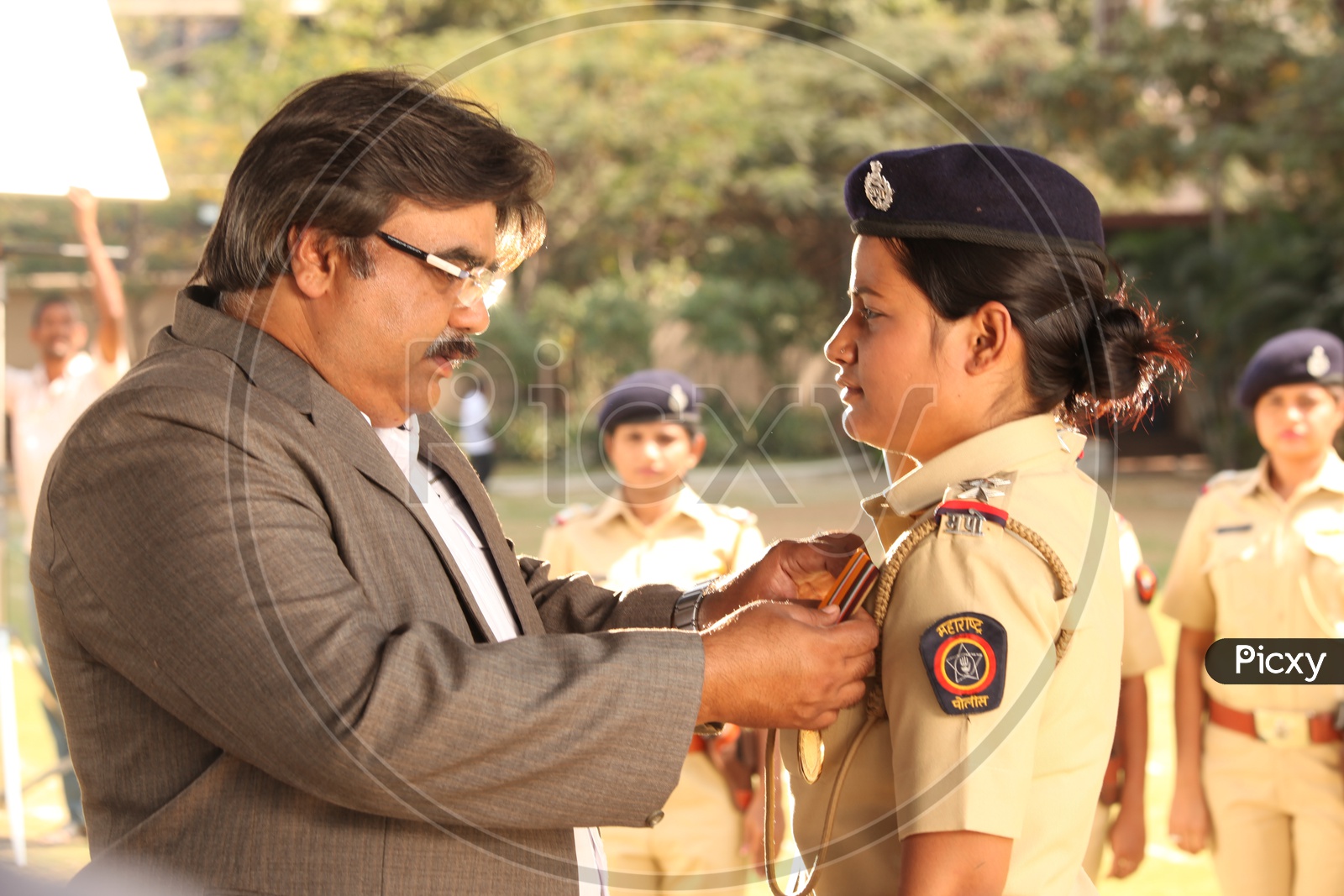 Young Woman Or Lady Police Receiving Gallantry Award From Officers