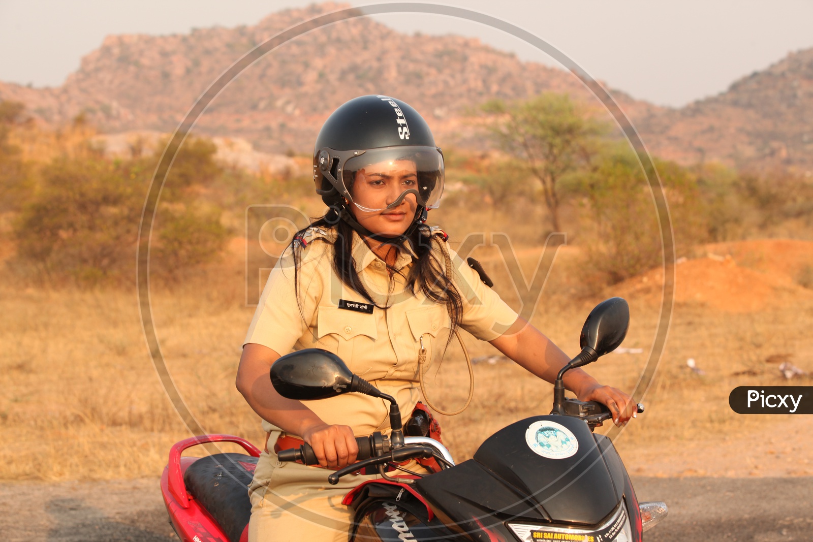 A Woman or Lady Police Riding a Bike
