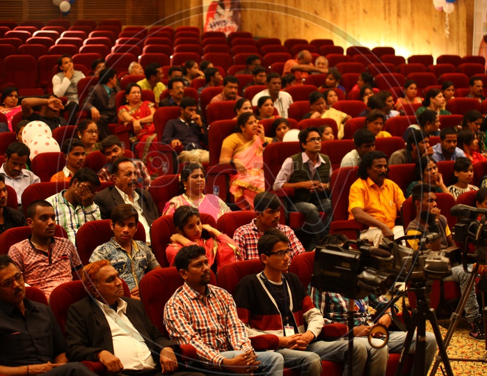 Crowd and Media Present in an Auditorium