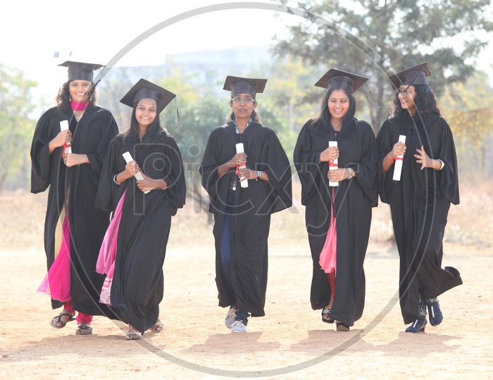 Young Indian  Students Wearing Graduation Day Dress