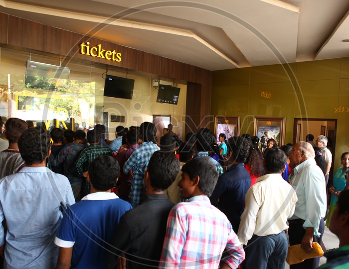 Fans Waiting at Tickets Counter in a Movie Theater