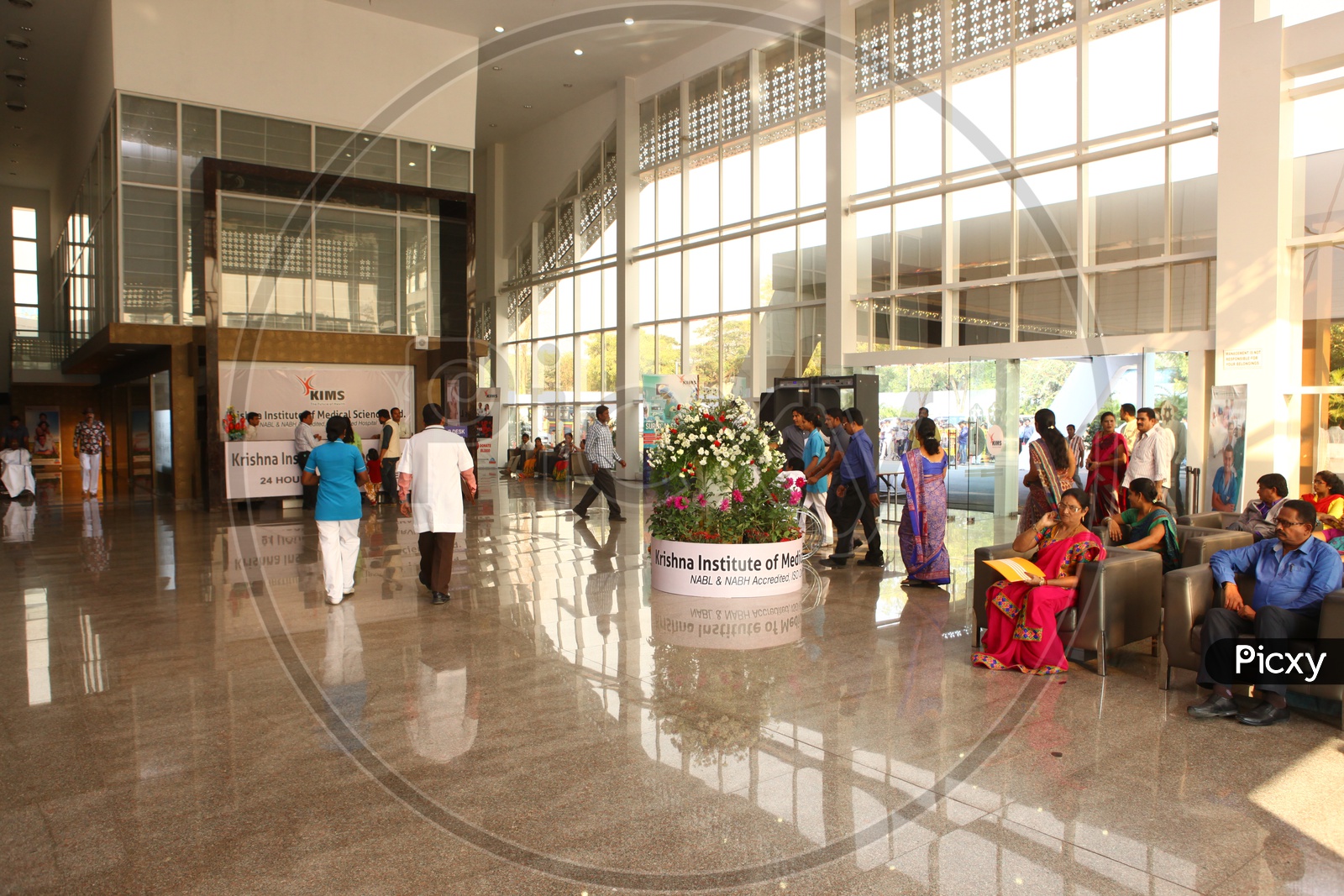 Hospital Reception Floor With Patients Waiting at Chairs