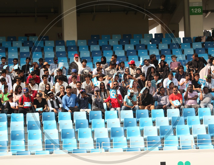 Fans Or Crowd Sitting In Stands in a Cricket Stadium