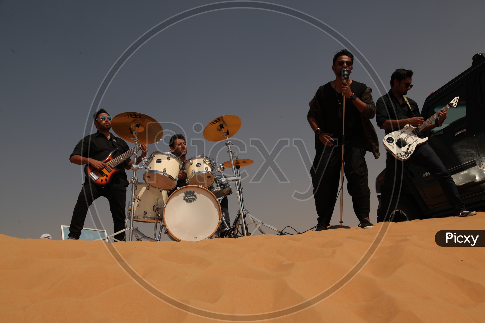 A Music Band Performing In Sand dunes of A Desert