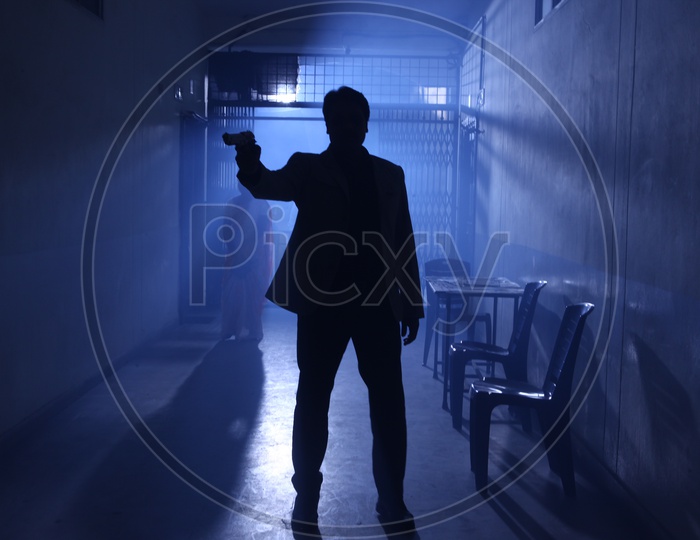 Silhouette Of a Man Holding Gun In Hand