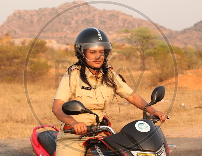 A Woman or Lady Police Riding a Bike