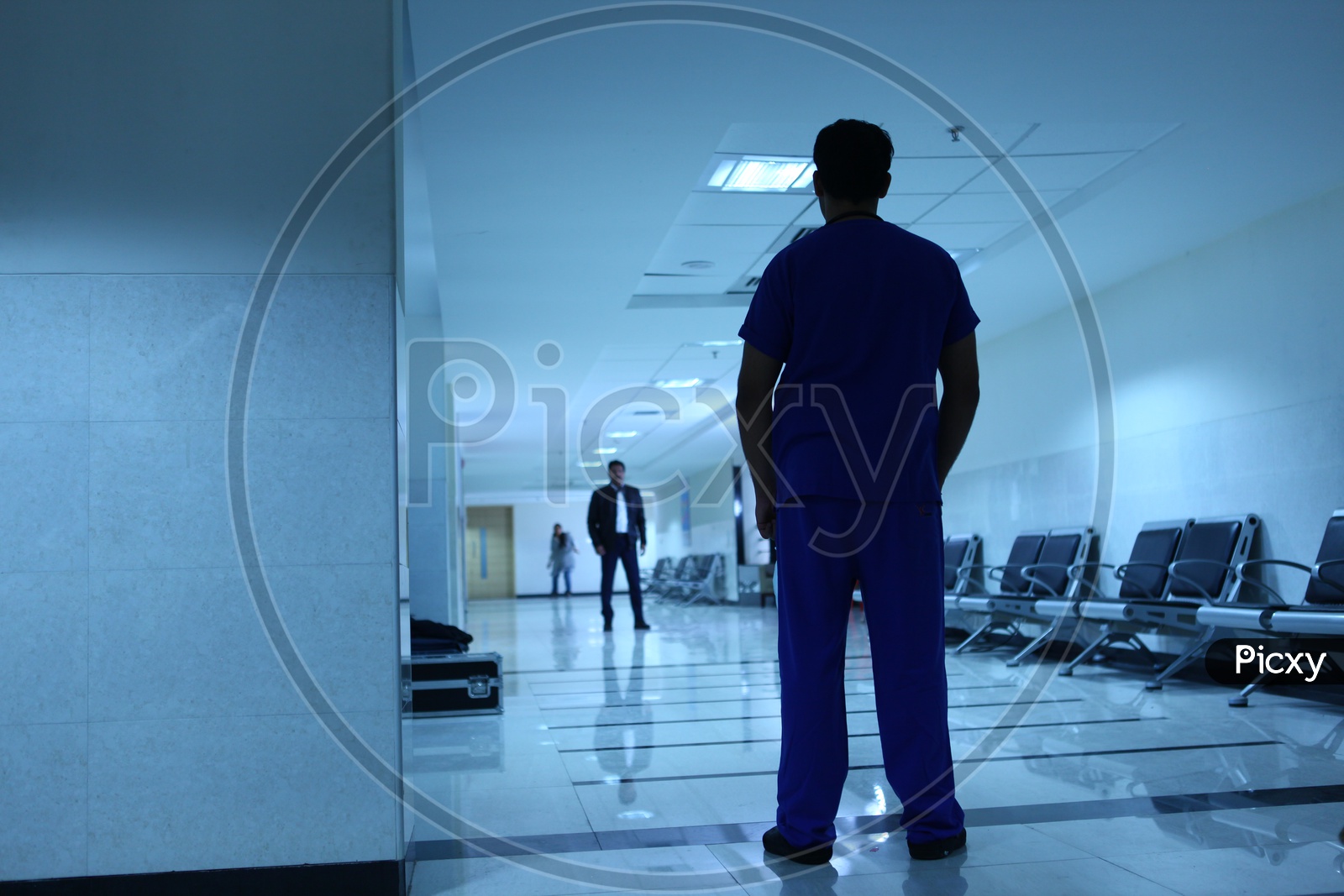 Silhouette Of People Standing In a Hospital Corridor