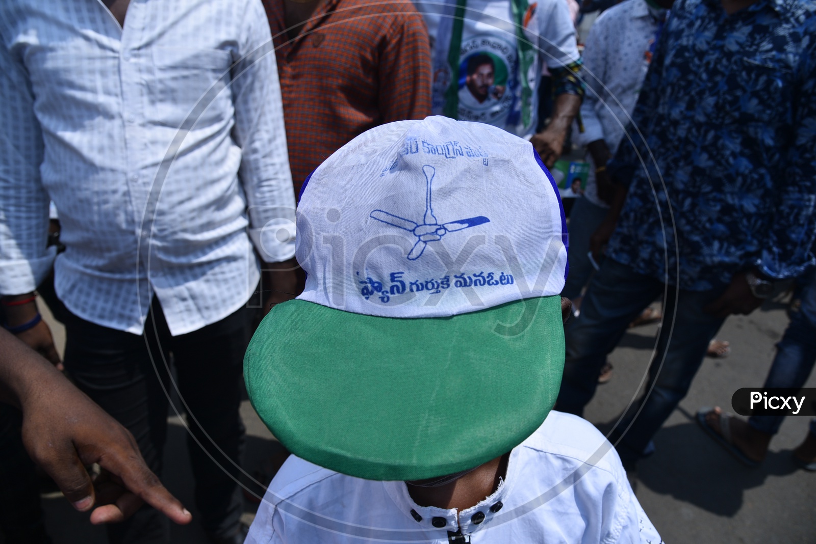 A Small Kid Wearing The YSRCP Supporter Cap During Election Campaign Rally