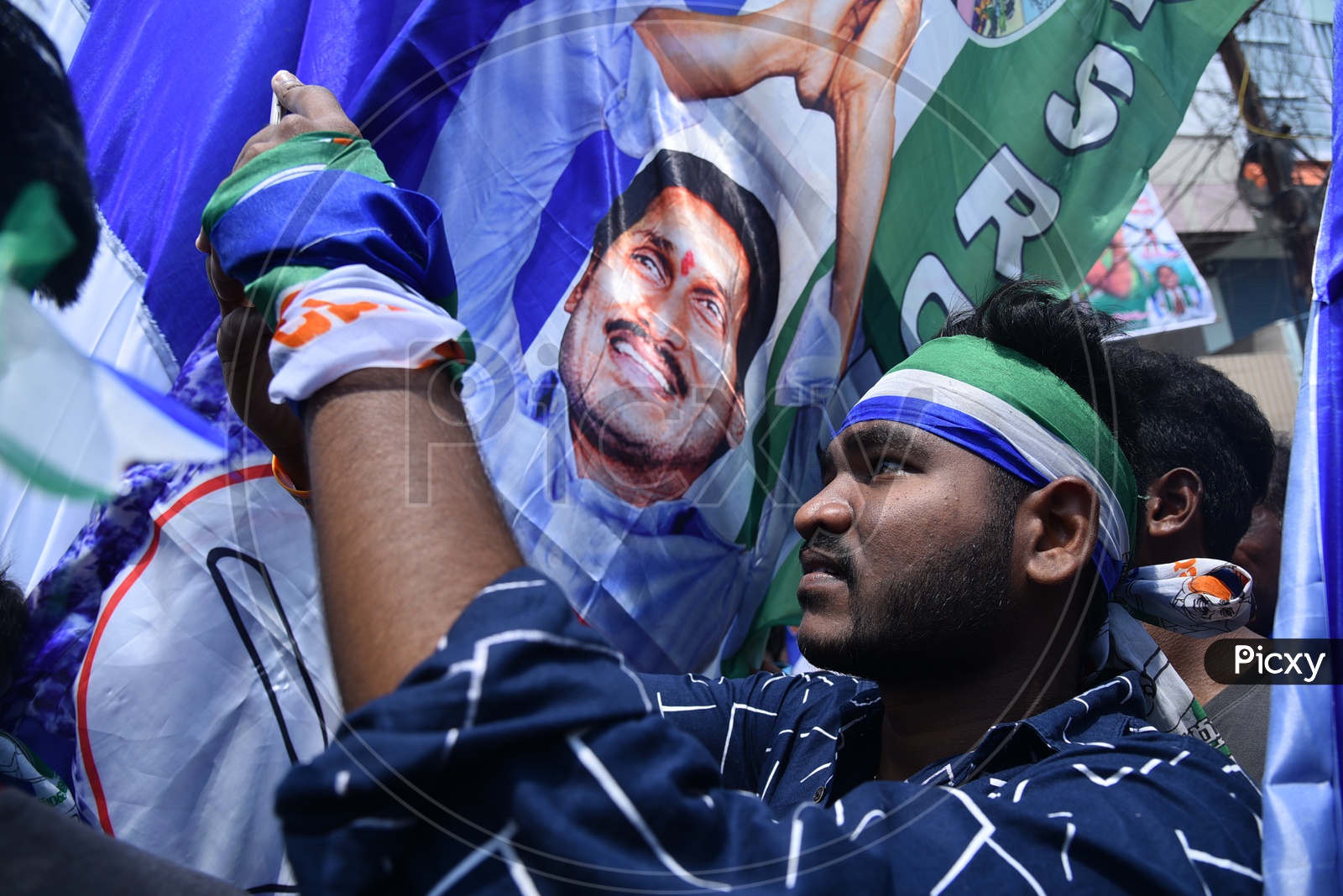 A YSRCP Party Supporter Taking Pictures During Election Rally
