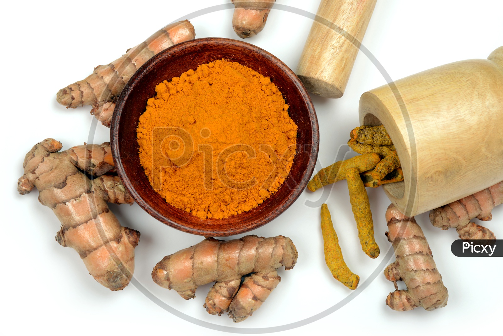 Organic Turmeric roots and Turmeric Powder in a bowl and wooden mortar, Indian spices