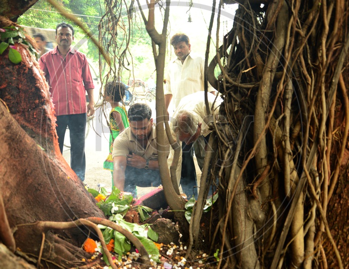 Indian Men offering prayers to Hindu snake god