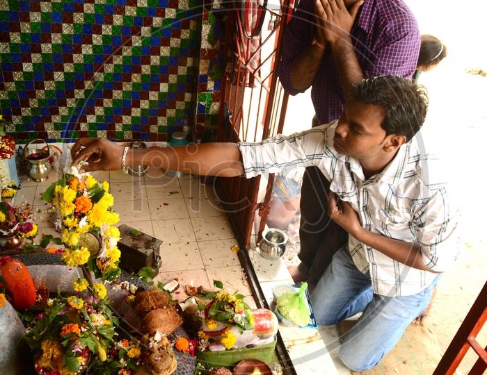 Indian men offering prayers in a temple