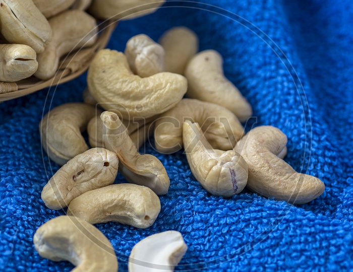 Cashew nuts in a basket on blue cloth