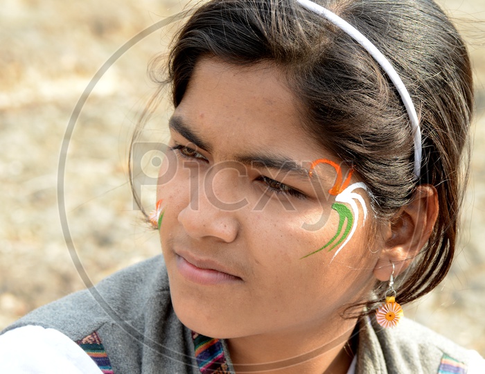 Indian Young People Pasting Indian National Tri-Colors On the Cheek Celebrating Independence Day