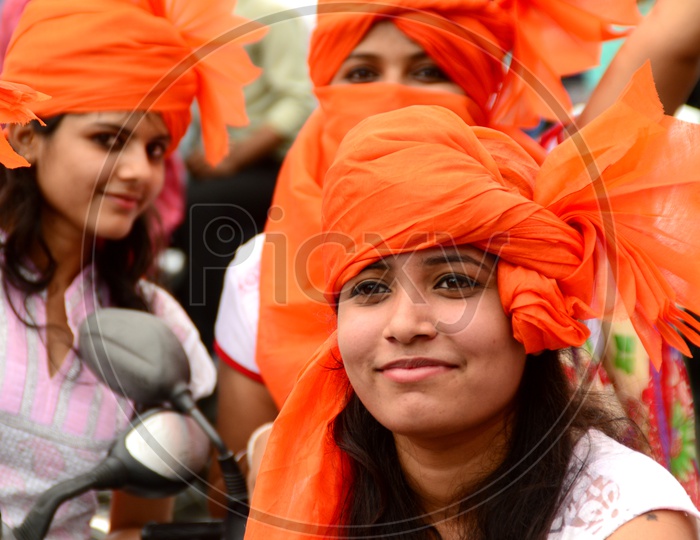 Indian Young Girls Wearing Saffron Turbans And White Clothes In Independence Day Celebrations