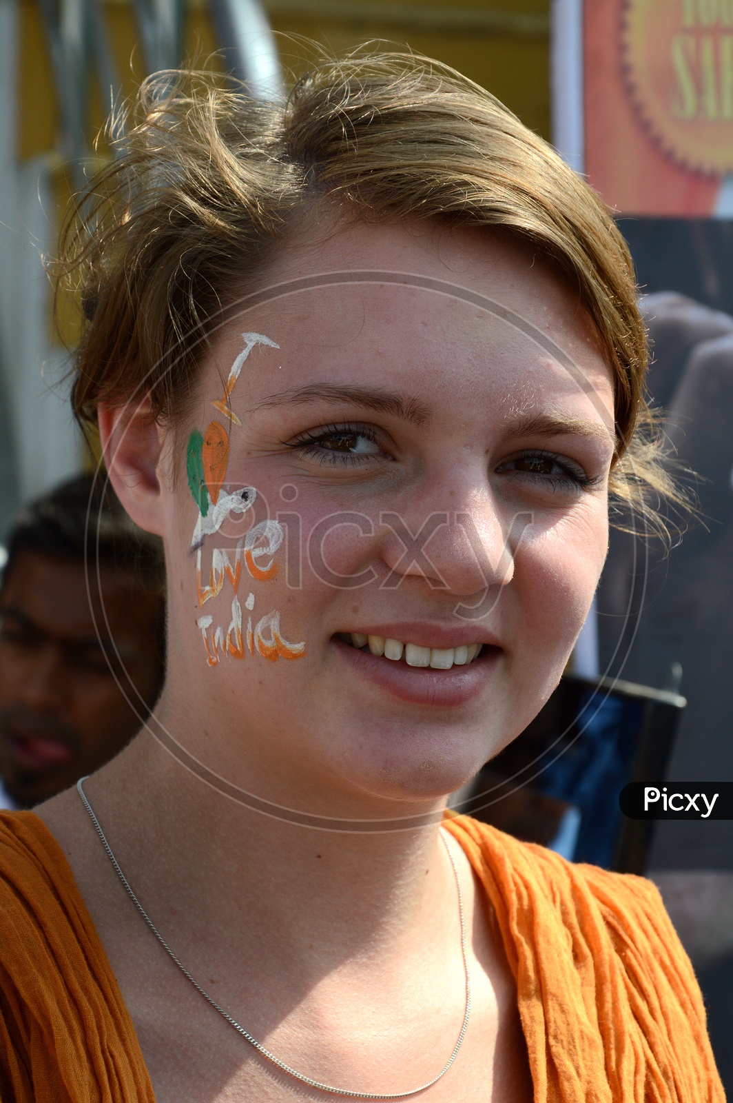 A Foreign Lady  Pasting Indian National Tri-Colors On the Cheek Celebrating Independence Day