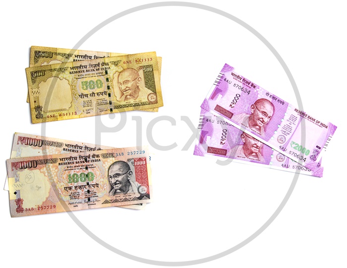 Indian New Currency Note Of 2000 Rupees With Demolished Old Currency Notes On An Isolated White Background